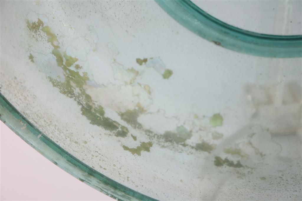 A Roman green glass dish, 1st/2nd century AD, 33cm across